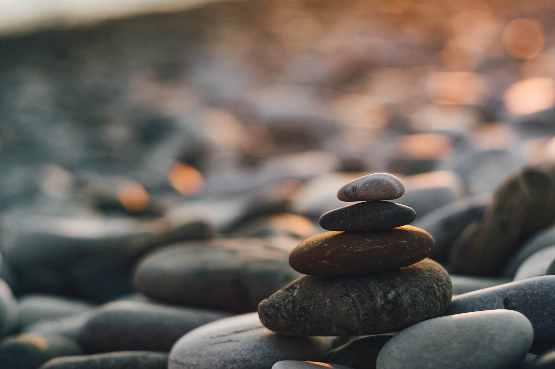 stack of zen stones on pebble beach folded pyramid Zen pebble stones on the sea beach at sunset